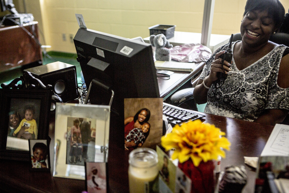 Administrative staff at the office at Booker T. Washington. In the left corner is a portrait of Myneishia Johnson, who was killed before her 2016 graduation.