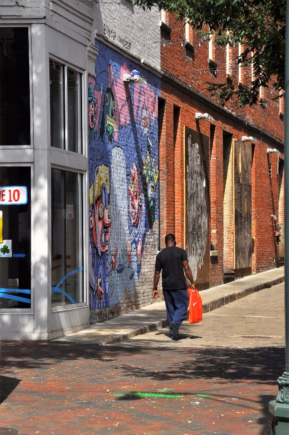 At night the Barboro Alley mural comes alive through the use of projectors playing moving images on the piece. The piece is by artists birdcap and ninjacat.