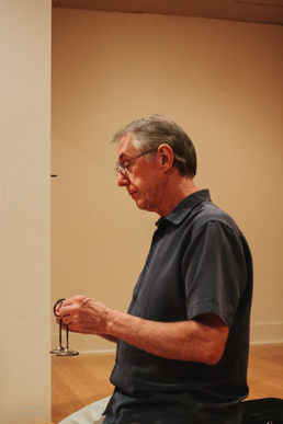 Dan Lamontagne signals the end of meditation with the ringing of cymbals.