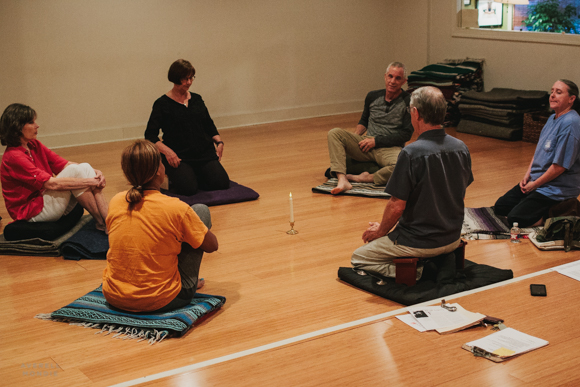 A candle sits at the center of the class.