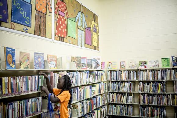 Rayjenae, 7, browses the books at the Cornelia Crenshaw Library.