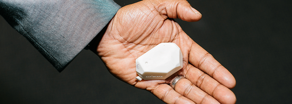 Sridhar Sunkara, CEO of ThinkProxi, holding a beacon device.