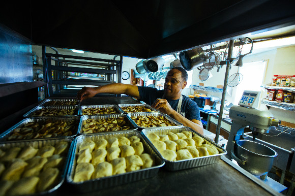 Daniel Watson checks on bread and cinnamon rolls.