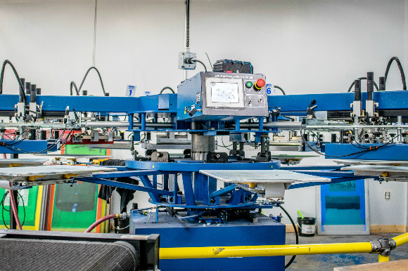 A screen printing machine works with Wilson's limited mobility.