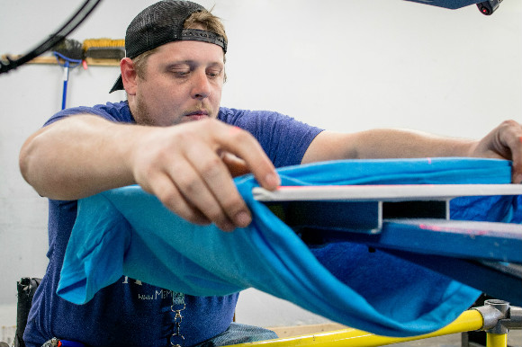 Wilson loading in a T-shirt to be printed.
