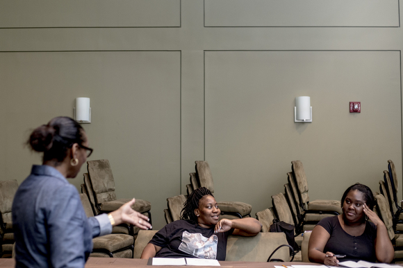 Joi Hibbler, an educator for Operation Smart Child, leads a conversation in the prenatal program for expectant mothers at the Neighborhood Christian Center in Smokey City.