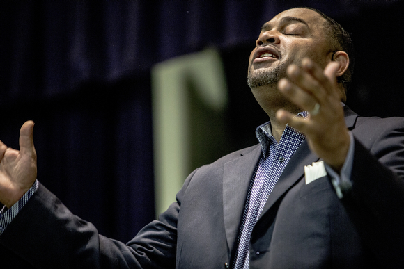 Pastor Colley Cooper preaches during Sunday service at Hope City Church in Caldwell-Guthrie's cafeteria in Smokey City.