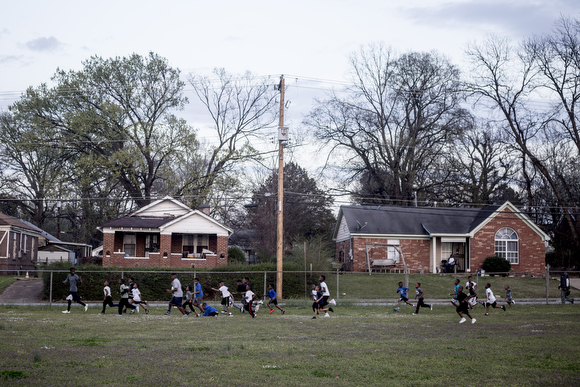 EJ Simmons leads a group of kids running laps around the field next to Katie Sexton Community Center in Klondike during practice for the North Memphis Steelers.