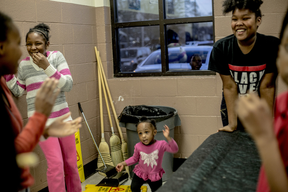 Aaliyah Griffin dances along with girls who are practicing cheers at the Dave Wells Community Center in Smokey City.