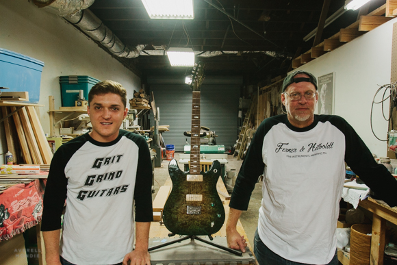 Hans Hilboldt & Kevin Ferner pose with a custom guitar in the Memphis Guitar Spa workshop