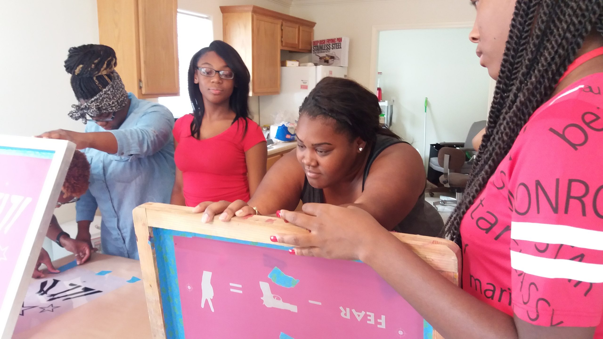 Participants screen print posters in the Klondike Smokey City apprenticeship program.