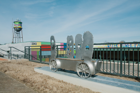 Pete Beeman's sculpture in the foreground of Loeb Properties' painted watertower in the Broad Avenue Arts District.