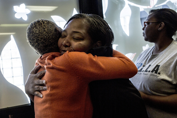 Irma Jones hugs Brenda Buckley, the practice manager at the Guthrie Primary Care Clinic in Smokey City, on her way out of the clinic.
