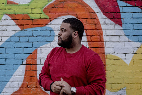 Eric Dunn, education advocate, poses for a portrait in Smokey City.