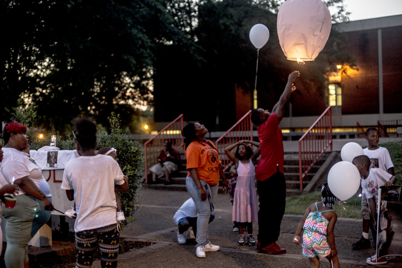 Lanterns are released at a vigil for victims of violence at Northside High School over the summer.