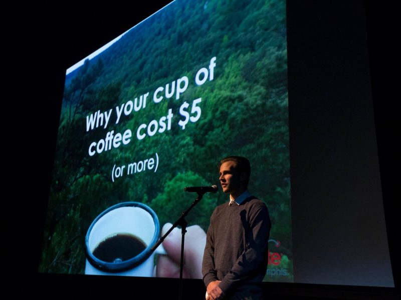 Brendan Larkin at Ignite Memphis, Vol. 9. delivering his talk "Why Your Cup of Coffee Costs $5"