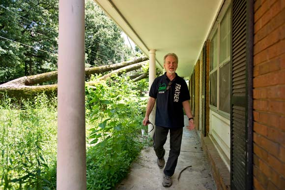 Lockwood walks outside a vacant house in Frayser. His organization is trying to add the home to the list of blighted properties they have turned around.