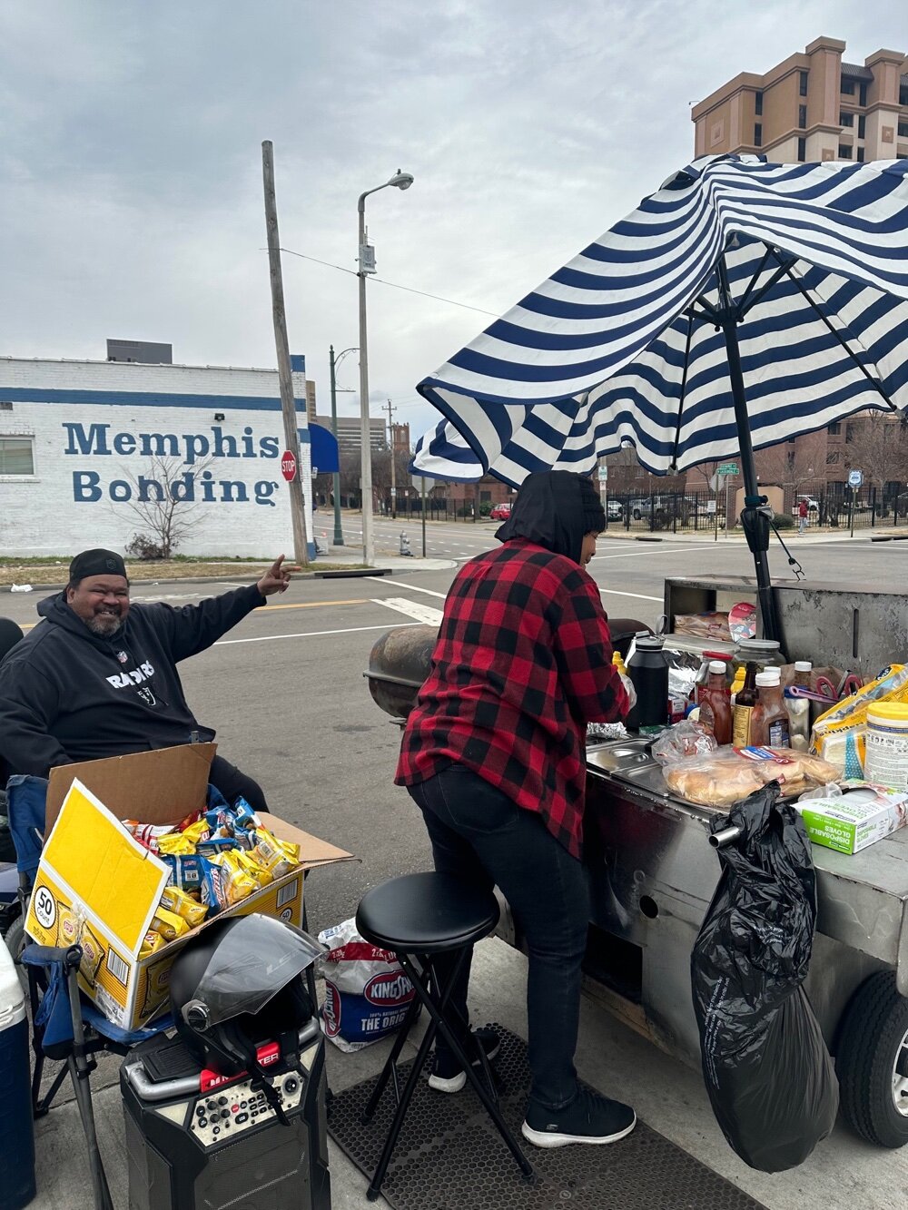 “This young lady and her son are really good people and her food is delicious,” says Mustafo, pictured here in black and a resident of Barry Towers. 
