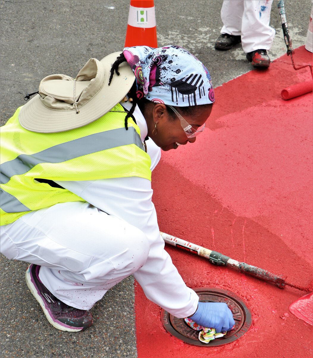Crew members for the Heights CDC work on traffic calming features to complement the new bioswale construction at Tutwiler and National. (Reginald Johnson)