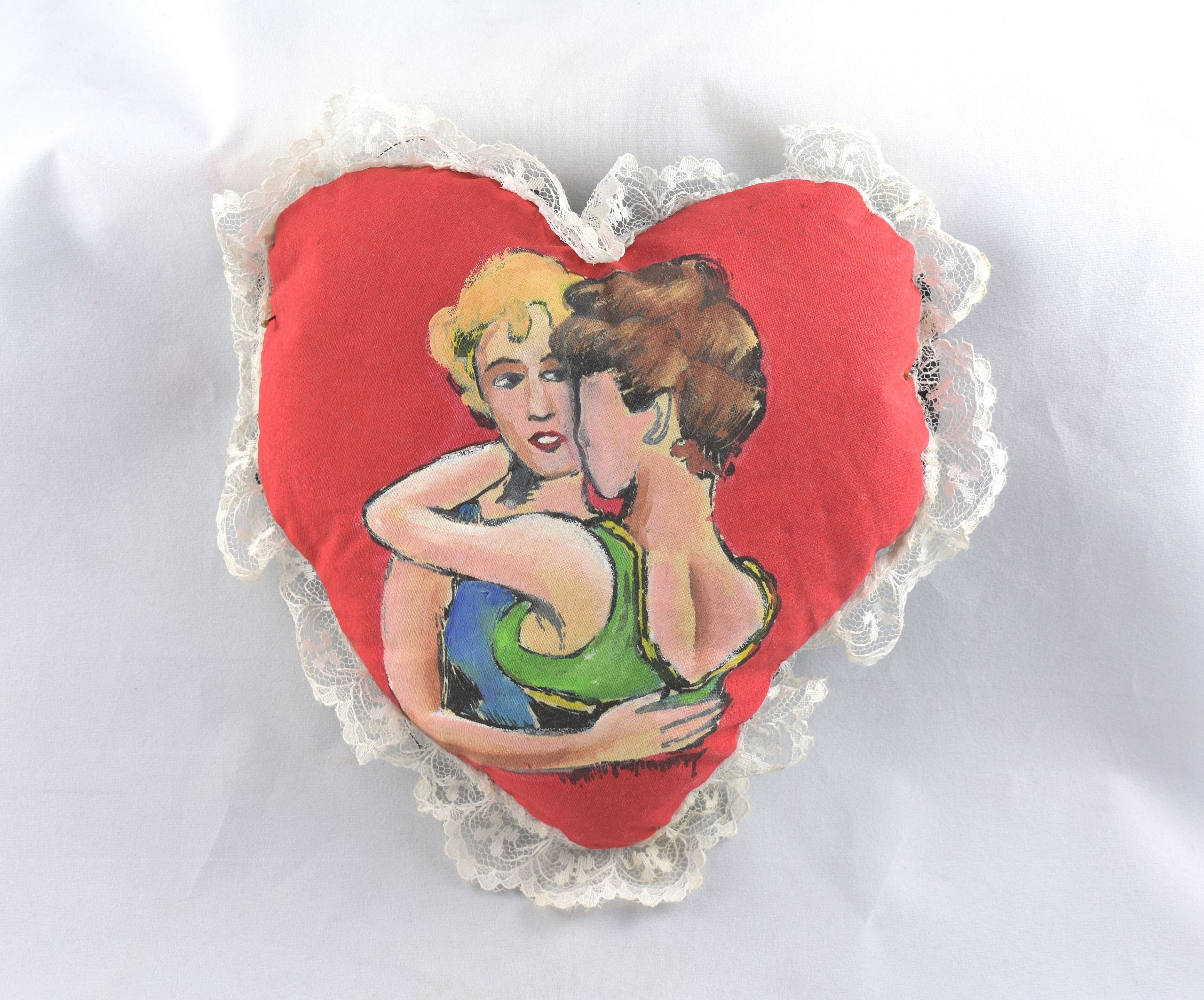 This hand-painted pillow shows two women embracing. It's a souvenir of the 1992 Gay Pride celebration. (photo courtesy of the Museum of Science & History)