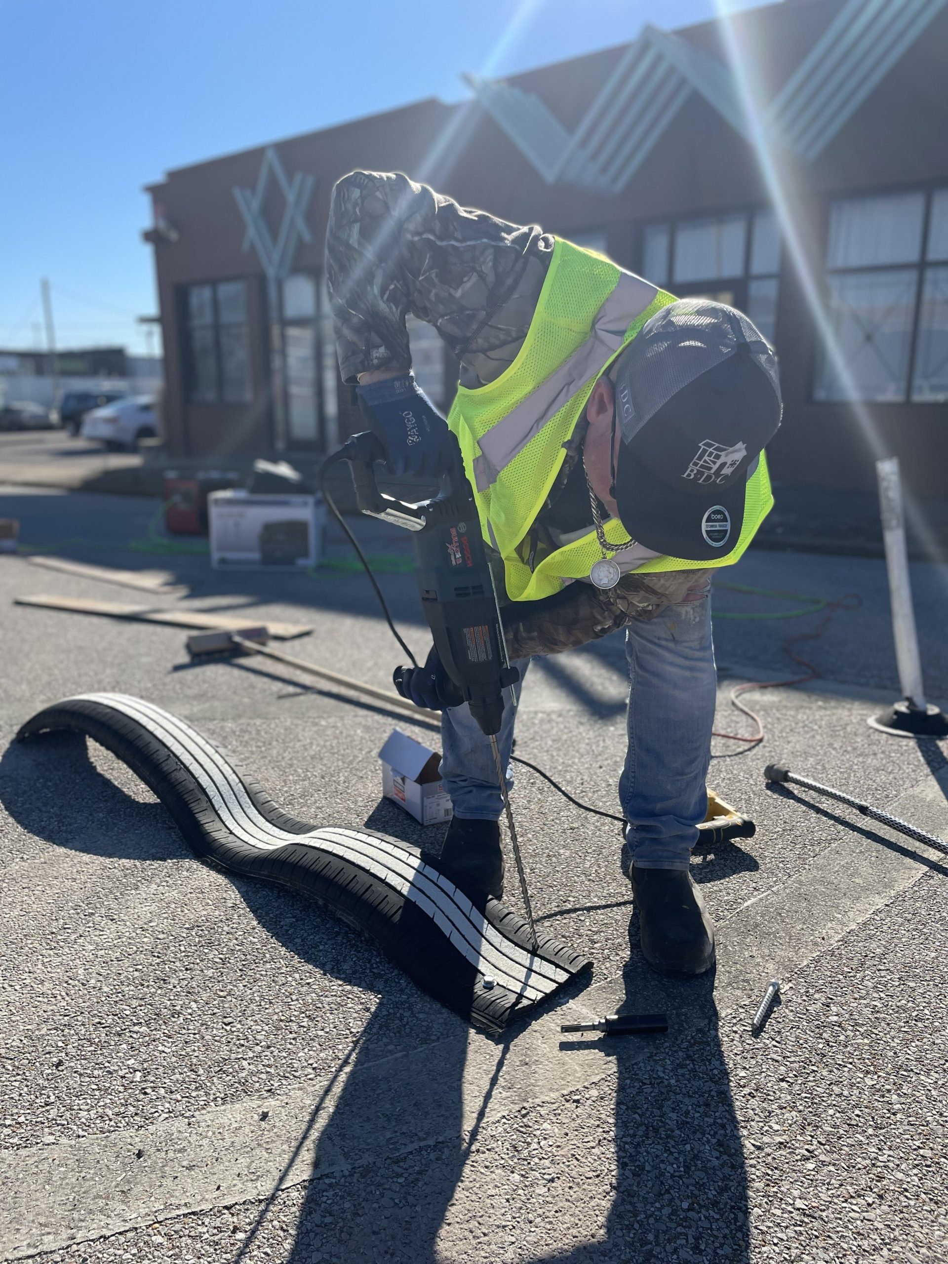 Crew members from Binghampton Development Corporation's Business Hub training program install recycled tire bike lane barriers. (submitted) 