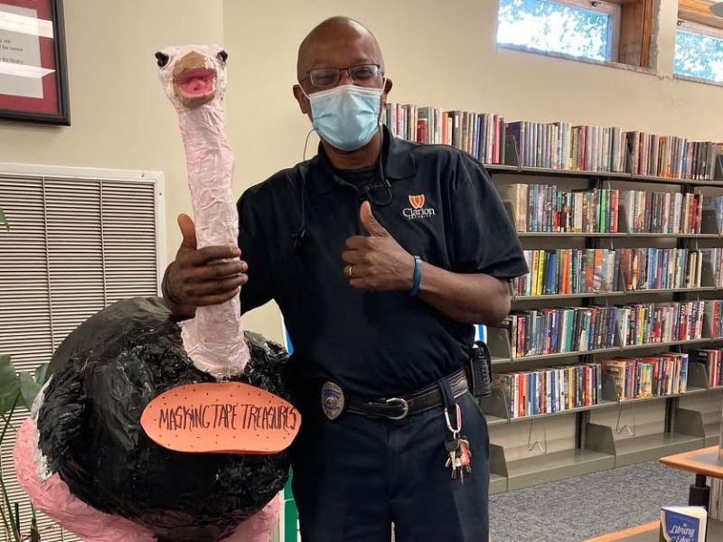 Artist James Harton poses next to his sculpture of an ostrich. (Leigh Tatum)