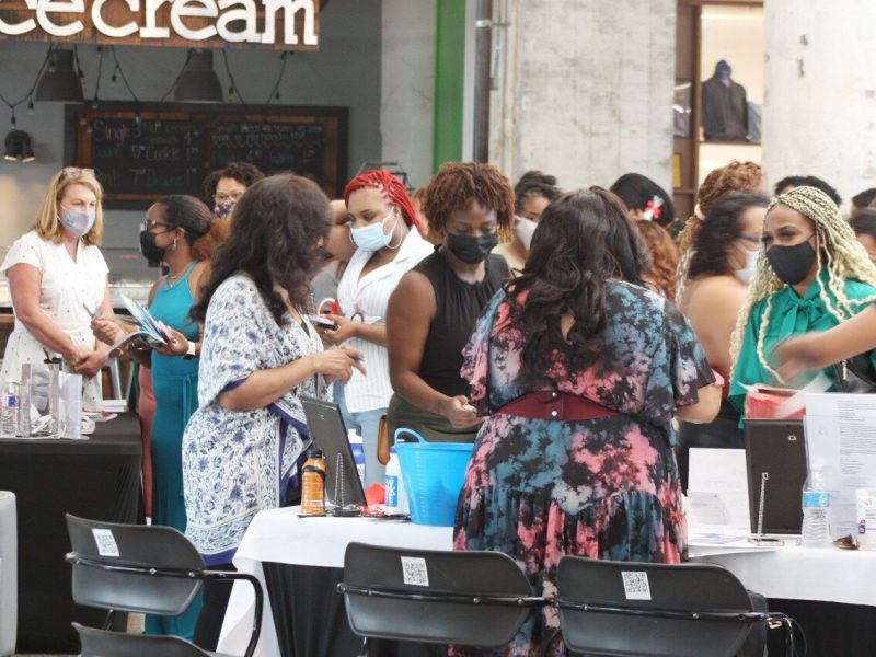 Attendees of the WBC South grand opening networked with each other and several women-owned businesses tabling the event, including New York Life Insurance Company (foreground) and LEO Events (background, left) (HGN / Cole Bradley)