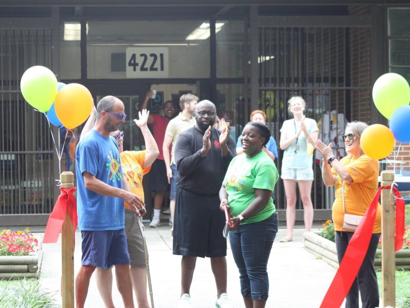 Christina Crutchfield with Heights CDC cuts the ribbon on the new Gaisman Park Arboretum. Chris Collier stands far left and Sheryl Sullivan stands far left. (Cole Bradley)