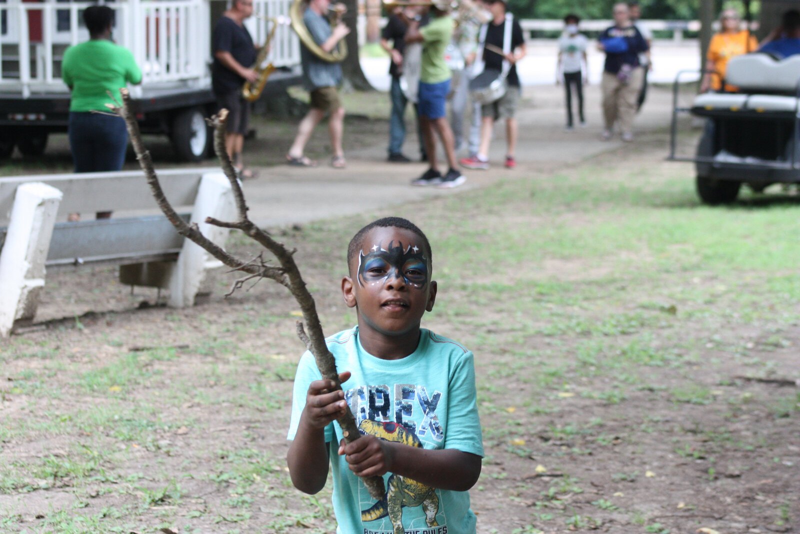 A young party goer shows off his Batman face paint and "Batman sword." (Cole Bradley)