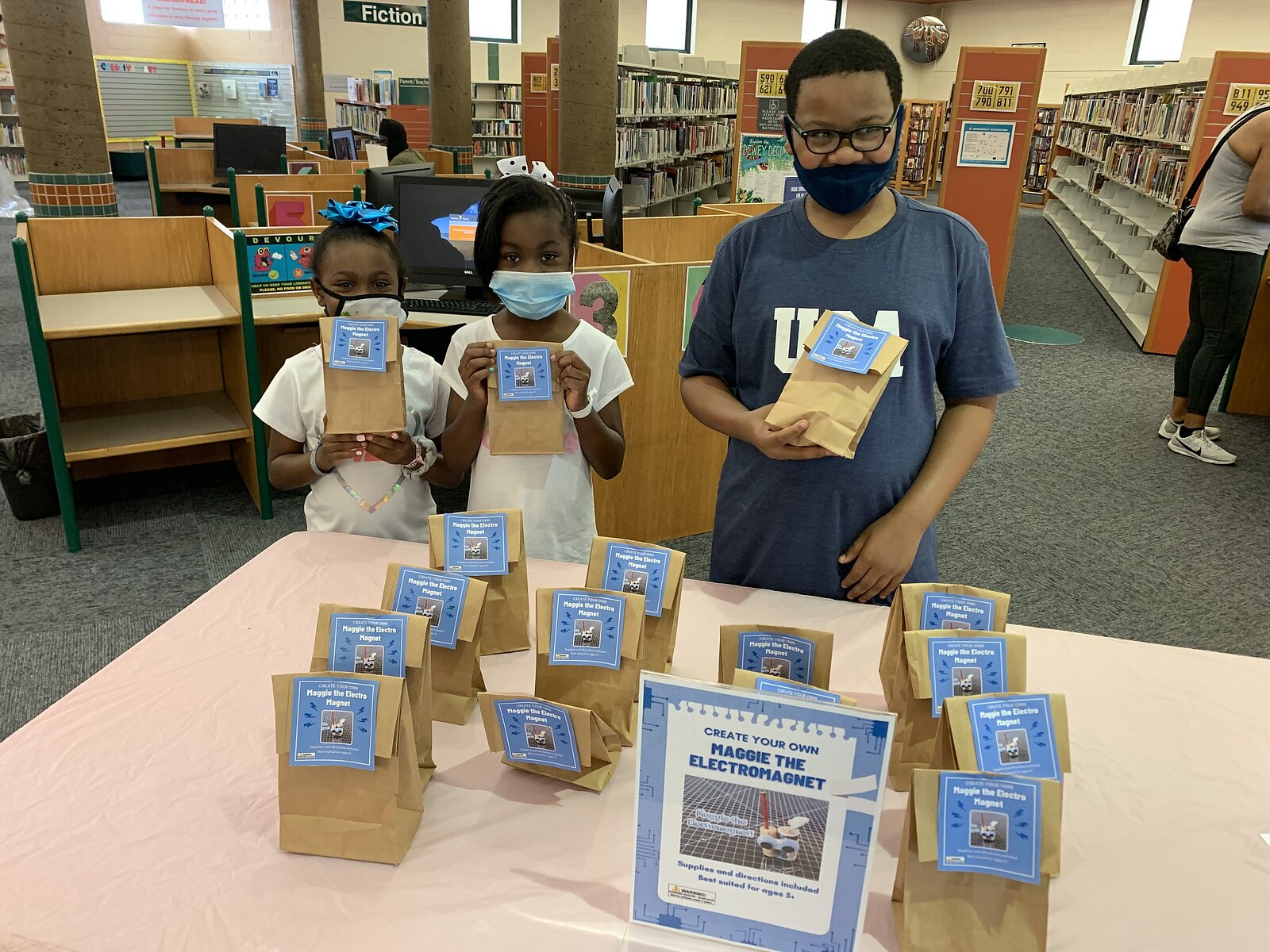 Kids at the North Branch Library pick up grab-and-go craft kids. They'll learn to make their own electromagnet. (Memphis Library Foundation)