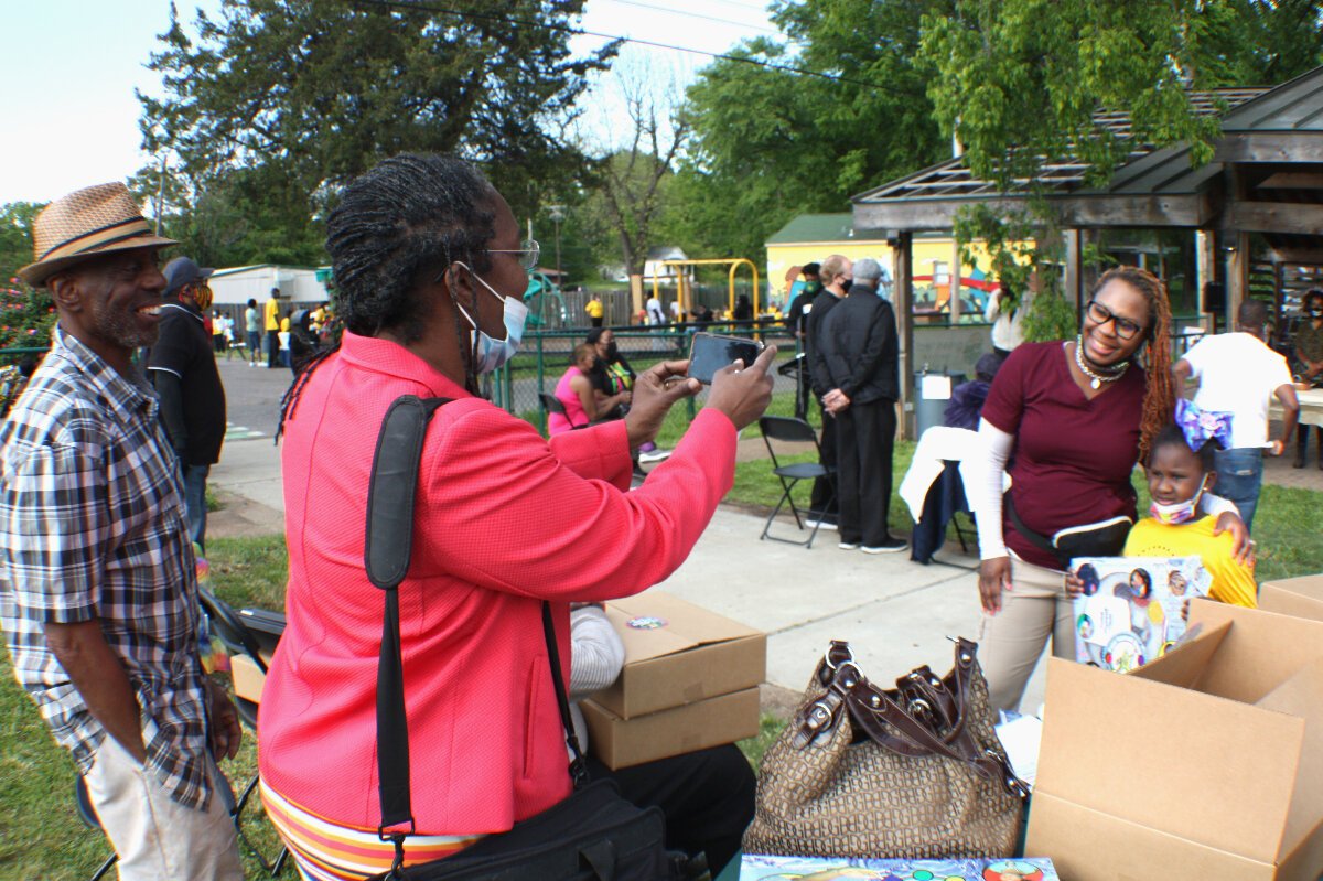 Larry and Sharonda Walker (left side) had six children who attended Knowledge Quest programming and have been longtime supporters of the organization. Part of the proceeds from their Paint Yourself Clean bath kit are donated to Knowledge Quest. For the Earth Day event, business partners in South Memphis sponsored a kit giveaway, which includes an activity book and musical "So Clean" award medallion. (Cole Bradley)
