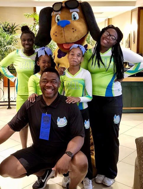 Craig Little, founder of the Sheriff’s & Police Activities League of Memphis & Shelby County, poses with PAL cheerleaders. (Submitted)