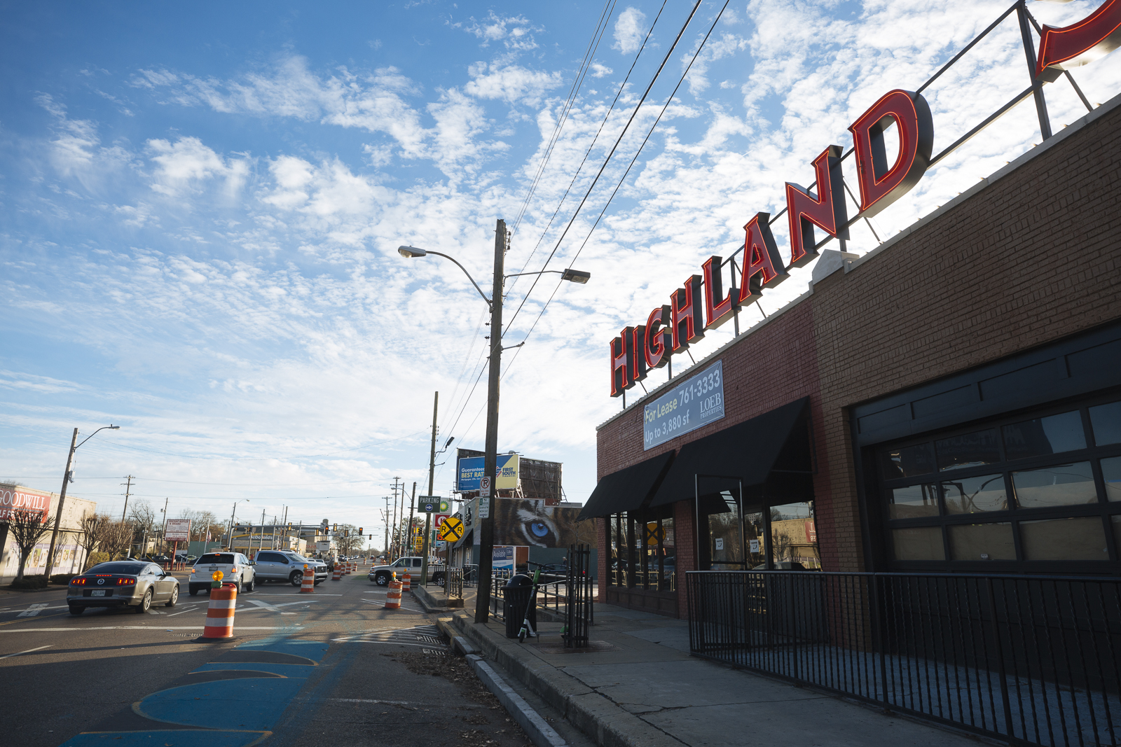 The Highland Strip features a bold sign to brand the area. Traffic cones mark street improvements, 2019. (Ziggy Mack)