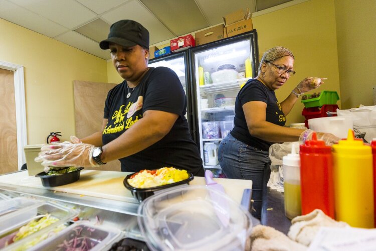 Stacy Bizzard (L) and Bonnie Harris prepare salads and sandwiches for hungry customers at Ms. B's Sub Shop. (Ziggy Mack)