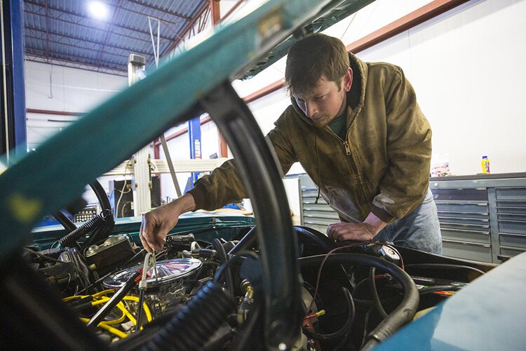 Ben Witherspoon works on customized cars at Turbo Kings in Whitehaven.
