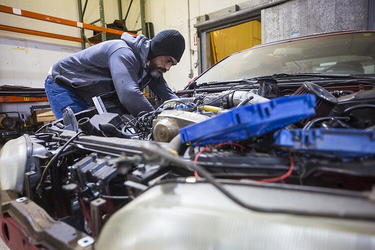 Muhsen "Moe" Najdawi works on customized cars at Turbo Kings in Whitehaven.