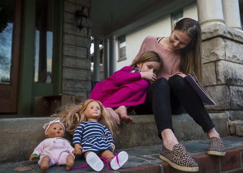 Victoria Kintner-Duffy sits on her porch in Central Gardens with her daughter. Her daughter is 6 1/2 years old and was diagnosed with autism at 4. Kintner-Duffy said it's been a years-long process to get a diagnosed and proper support. (Ziggy Mack)