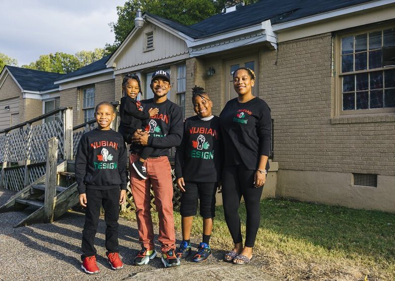 James Cook and his family stand outside the future home of Nubian Design Studios in Whitehaven. The building is currently under renovations with help from an EDGE Inner City Economic Development loan . (Ziggy Mack)