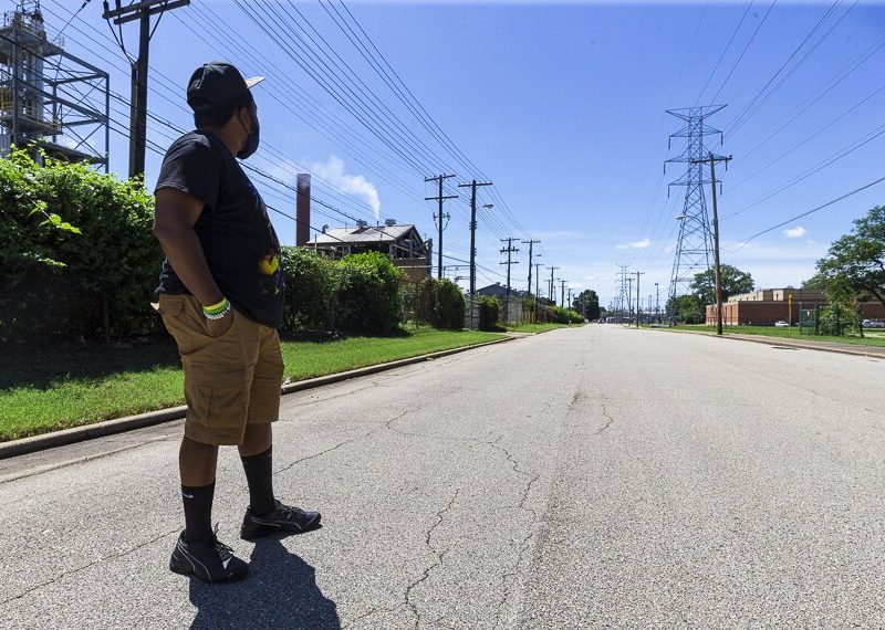 Frank Johnson looks towards North Memphis' Penn A Kem, LLC  chemical plant on the left hand side of the road. On the right is Douglass High School. (Ziggy Mack)