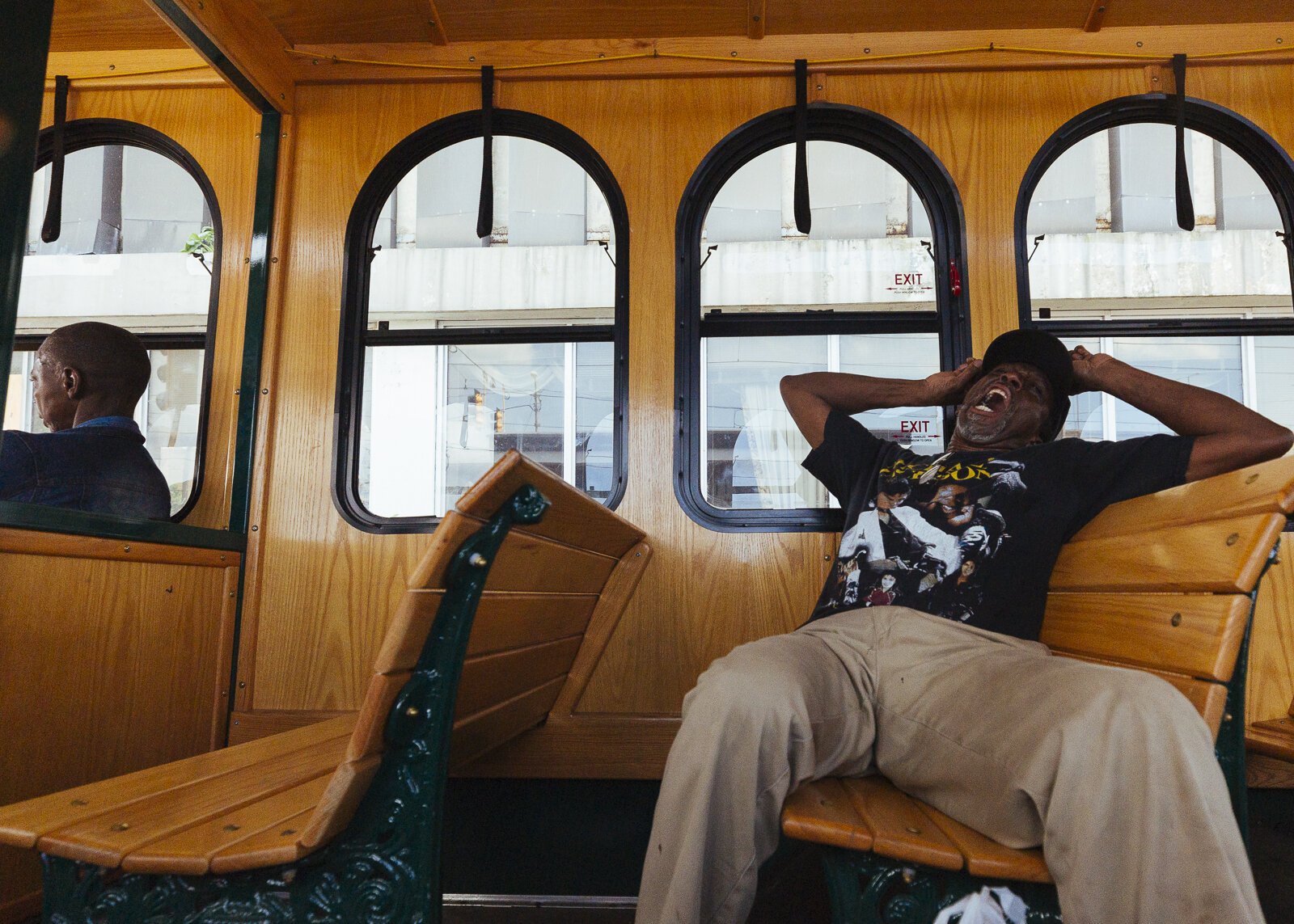 Self-identified street-level activist and Madison Avenue trolley bus passenger Larry White yawns and stretches as he rides along the trolley route through the Medical District. 2019. (Ziggy Mack)
