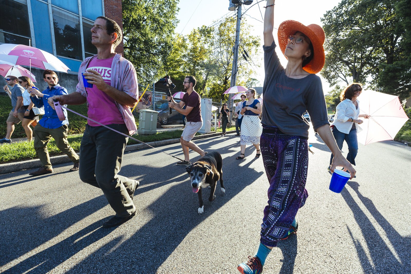 A second line jazz parade winds through the streets of Madison Heights to celebrate the community and the Rain or Shine umbrella-share project. 2019. (Ziggy Mack)
