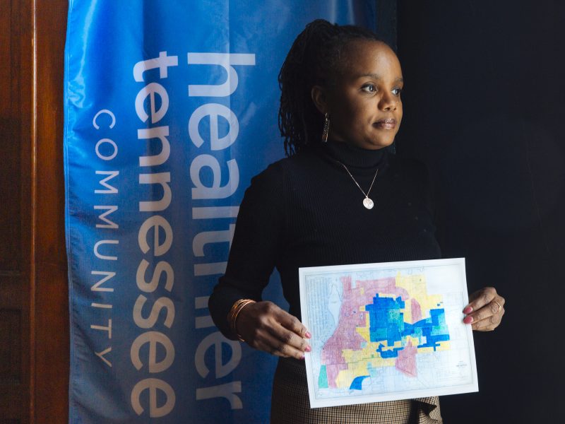 Roshun Austin, president and CEO of The Works, Inc. holds a redlining map created in the 1930s. (Ziggy Mack)