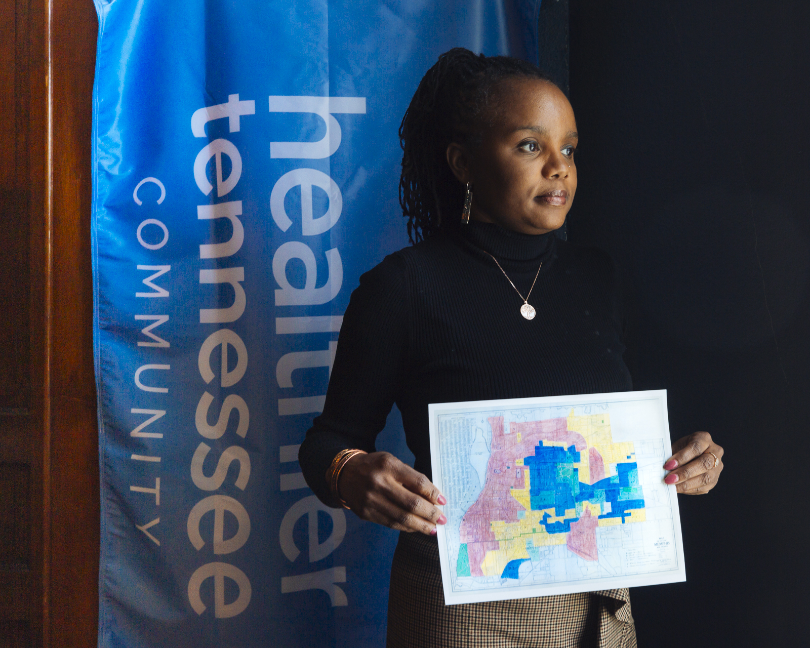Roshun Austin, president and CEO of The Works, Inc. holds a redlining map drawn in the 1940. The map is proof of intentional housing policies meant to undermine black wealth and black communities. 