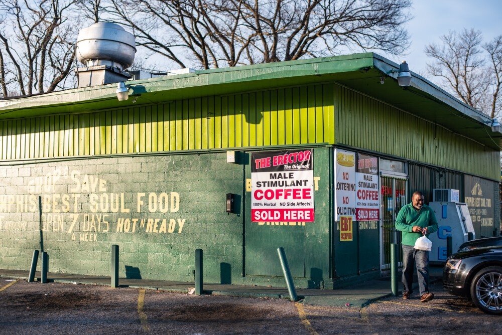 A satisfied customer heads to his vehicle after getting a soul food plate at Shop & Save on South Third Street. (Malik Martin)