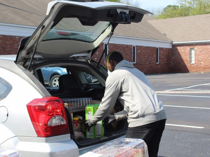A volunteer with the Neighborhood Christian Center packs a family’s car with a week’s worth of meals. NCC is one of the organizations that has received funding from the Mid-South COVID-19 Regional Response Fund. (Submitted)