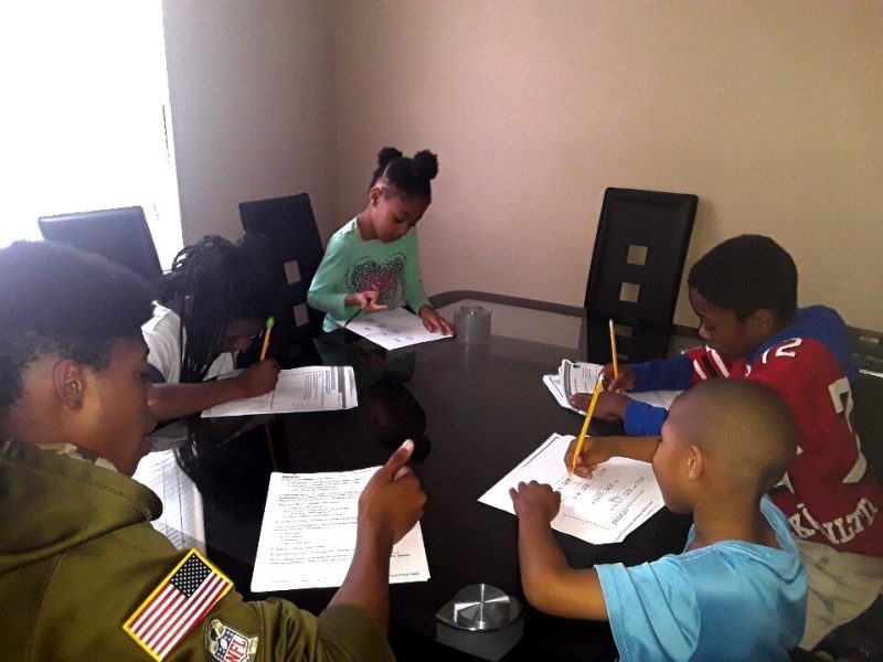 The Covid-19 crisis has caused Christina Ueal’s dining table to become a classroom. Her five children, ages five to 15, work on packets provided by their schools at their home in Frayser. (Submitted)