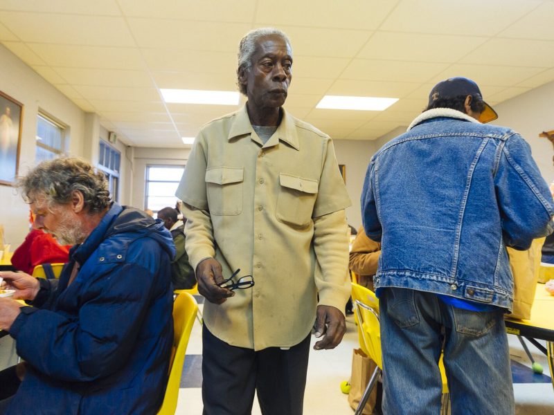 Pastor Jeffrie Howard, center, walks through diners at the Society of St. Vincent de Paul of Memphis's Ozanam Food Mission, March 2019. It was one of two area locations that served hot meals daily. COVID-19 has closed many soup kitchens. (Ziggy Mack)