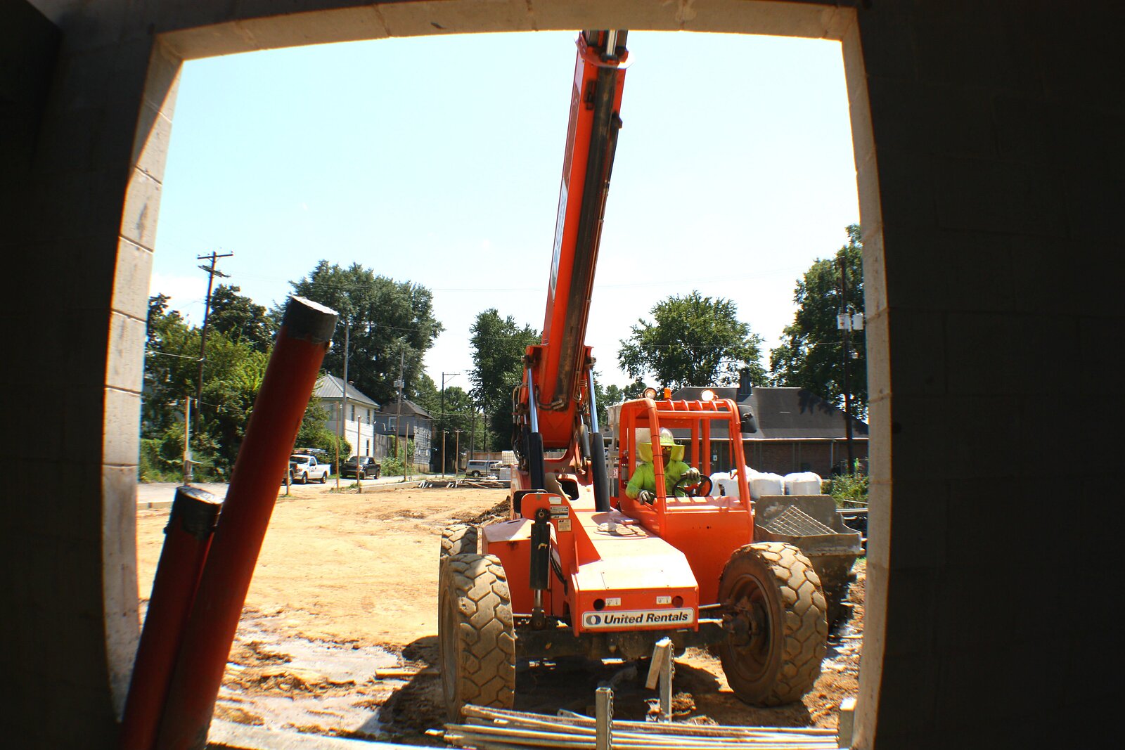 A construction worker maneuvers equipment on the exterior of CHOICES' new full-spectrum reproductive center during an earlier phase of construction. The building is now nearing competition and will open in April. (Cole Bradley)