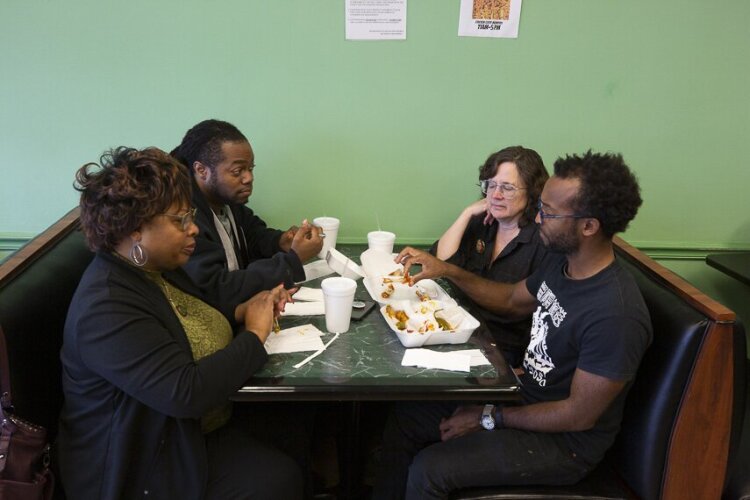 The team pushes through to take down the last hot wings in the Winchester Road tasting challenge. Clockwise from front left: Hickory Hill resident Connice Nunn and High Ground team members A.J. Dugger, Emily Trenholm, and Ziggy Mack. (Cole Bradley)