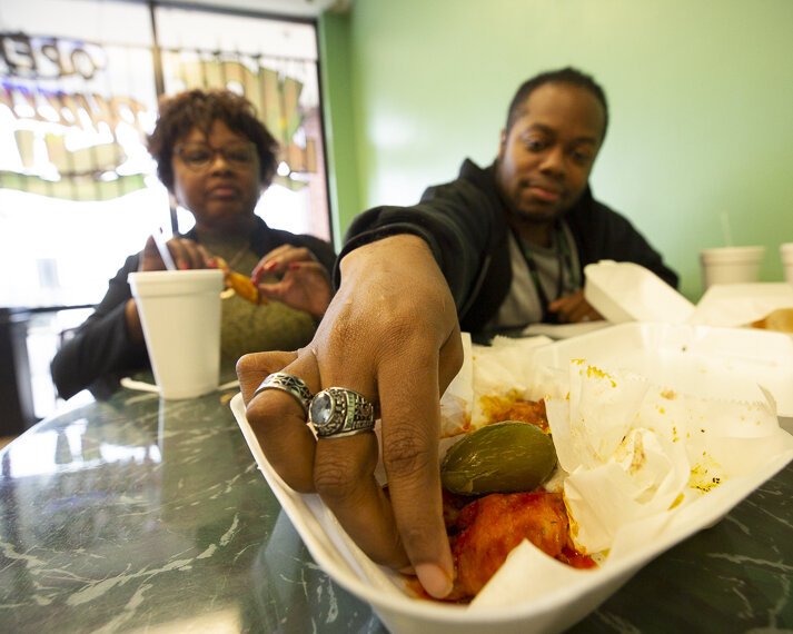 A.J. Dugger reaches for a hot wing at The Chicken Coop, located at 6665 Winchester Road in Hickory Hill. (Ziggy Mack)